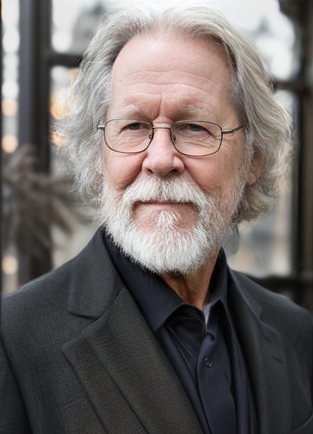 August Iverson, author of the Seasonal Psychology series, with gray hair, glasses, and a thoughtful expression in a dark suit.